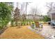 Well-maintained backyard featuring a patio area, lush greenery, and mature trees, perfect for outdoor living at 5358 Birdie Ln, Hollywood, SC 29449
