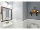 Charming half-bath features updated vanity, shiplap accents, and stylish rustic decor at 5358 Birdie Ln, Hollywood, SC 29449