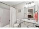 Bright bathroom featuring a shower/tub combo with a white shower curtain and vanity with granite countertop at 5358 Birdie Ln, Hollywood, SC 29449