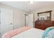 Bright and cozy bedroom featuring soft colored bedding and a full dark wood dresser at 5358 Birdie Ln, Hollywood, SC 29449