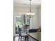 Charming dining area with a chandelier, view of the deck through sliding glass doors, and stylish decor at 5358 Birdie Ln, Hollywood, SC 29449