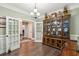 Dining area with built in china cabinet and view to another room through glass doors at 5358 Birdie Ln, Hollywood, SC 29449