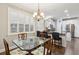 Dining room with glass table, shuttered windows and kitchen access at 5358 Birdie Ln, Hollywood, SC 29449