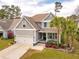 Charming two-story home with a well-manicured lawn, garage, and inviting front porch at 5358 Birdie Ln, Hollywood, SC 29449