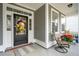 Inviting front porch with black door, seasonal wreath, and comfortable seating at 5358 Birdie Ln, Hollywood, SC 29449