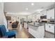 Bright, open kitchen with white cabinets, granite countertops, stainless steel appliances, and hardwood flooring at 5358 Birdie Ln, Hollywood, SC 29449