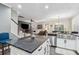 Beautiful kitchen with large island, stainless steel sink, and open layout connecting to the living area at 5358 Birdie Ln, Hollywood, SC 29449