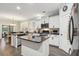 Kitchen with black countertops, white cabinets, stainless steel appliances and a large island at 5358 Birdie Ln, Hollywood, SC 29449