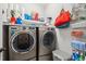 Efficient laundry room featuring front load washer and dryer with convenient shelving for storage and supplies at 5358 Birdie Ln, Hollywood, SC 29449