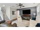 Living room with dark accent wall, hardwood floors, and large television at 5358 Birdie Ln, Hollywood, SC 29449