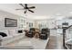 Open-concept living room that flows to kitchen with stainless steel appliances and hardwood floors at 5358 Birdie Ln, Hollywood, SC 29449