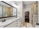 Luxurious main bathroom with dual vanities, a walk-in closet, and a tile shower at 5358 Birdie Ln, Hollywood, SC 29449