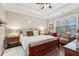Serene main bedroom with tray ceilings, hardwood floors, and a cozy sitting area at 5358 Birdie Ln, Hollywood, SC 29449