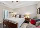 Tranquil main bedroom featuring a tray ceiling, natural light, and hardwood flooring at 5358 Birdie Ln, Hollywood, SC 29449