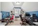 Well-lit home office with built-in shelving, dual workstations, and a cozy reading nook at 5358 Birdie Ln, Hollywood, SC 29449
