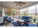 Screened porch with plush seating, ceiling fan, and outdoor views at 5358 Birdie Ln, Hollywood, SC 29449