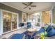 Cozy screened porch with comfortable seating and outdoor view at 5358 Birdie Ln, Hollywood, SC 29449