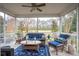 Screened-in porch with seating and golf course view at 5358 Birdie Ln, Hollywood, SC 29449