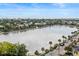 Beautiful aerial shot of the city featuring a pond with palm trees lining the street and various rooftops at 55 Ashley Ave # 19, Charleston, SC 29401