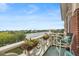 Scenic balcony view overlooking a tranquil lake, accented with potted plants and elegant outdoor seating at 55 Ashley Ave # 19, Charleston, SC 29401