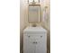 Clean powder room with a white vanity, modern faucet, and a decorative mirror at 55 Ashley Ave # 19, Charleston, SC 29401