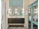Stylish bathroom with double vanity, striking tile accent wall, and an antique cabinet at 55 Ashley Ave # 19, Charleston, SC 29401
