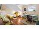 Sun-filled bedroom featuring a charming desk, a comfortable chair and a cozy bed with wood floors at 55 Ashley Ave # 19, Charleston, SC 29401