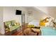 A cozy bedroom with a comfortable seating area, a sleek TV, and an open doorway to another room at 55 Ashley Ave # 19, Charleston, SC 29401