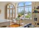Bright dining area features a glass table with chairs, a decorative bookshelf, and a view outside at 55 Ashley Ave # 19, Charleston, SC 29401