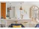 Modern kitchen featuring white cabinets, stainless steel appliances, gold accents, and copper pendant lighting at 55 Ashley Ave # 19, Charleston, SC 29401