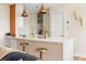 Modern kitchen with white cabinets, stainless steel appliances, gold accents, and copper pendant lights at 55 Ashley Ave # 19, Charleston, SC 29401