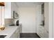 Modern kitchen with stainless steel appliances, white cabinets, and gold hardware and backsplash at 55 Ashley Ave # 19, Charleston, SC 29401