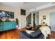 Stylish living room with hardwood floors, comfortable seating, and a unique turquoise cabinet feature at 55 Ashley Ave # 19, Charleston, SC 29401