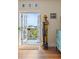Living room view with open doors to a balcony, alongside a folk art sculpture at 55 Ashley Ave # 19, Charleston, SC 29401