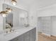 Bright bathroom featuring double sinks, quartz countertops, gold fixtures, and an open closet at 6 Allison Ct, Charleston, SC 29407