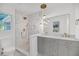 Modern bathroom with double vanity, walk-in shower, decorative tile, and stylish fixtures at 6 Allison Ct, Charleston, SC 29407