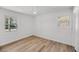 Bedroom with hardwood floors, closet, and two windows providing natural light at 6 Allison Ct, Charleston, SC 29407