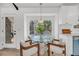 Dining area featuring a modern round glass table, stylish chairs, and large windows for ample natural light at 6 Allison Ct, Charleston, SC 29407