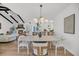 Bright and airy dining room with modern lighting, flowing into a living room featuring a fireplace at 6 Allison Ct, Charleston, SC 29407