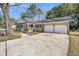 Brick home with white trim, an attached garage, and a wide driveway, offering ample parking space at 6 Allison Ct, Charleston, SC 29407
