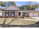 Charming single-story brick home featuring a well-manicured lawn, attached garage, and inviting entryway at 6 Allison Ct, Charleston, SC 29407