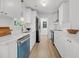 Galley kitchen with white cabinets, stainless steel appliances, quartz countertops, and modern hardware at 6 Allison Ct, Charleston, SC 29407