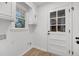 Small, bright laundry room featuring natural light and a door to the outside at 6 Allison Ct, Charleston, SC 29407