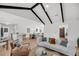Bright living room featuring vaulted ceiling, dark beams, and an open floor plan with kitchen and dining areas at 6 Allison Ct, Charleston, SC 29407
