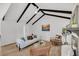 Bright living room featuring vaulted ceiling, dark beams, a fireplace, and neutral toned modern furniture at 6 Allison Ct, Charleston, SC 29407