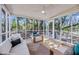Bright sunroom featuring wood floors, floor-to-ceiling windows, and cozy seating, offering seamless indoor-outdoor living at 6 Allison Ct, Charleston, SC 29407
