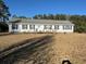 Charming single-story home featuring black shutters and a welcoming front porch with a ramp at 60 Caboose Ct, Cottageville, SC 29435