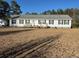 Charming single-story home featuring black shutters and a welcoming front porch at 60 Caboose Ct, Cottageville, SC 29435