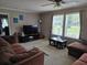 Cozy living room with a large sofa and two windows providing ample natural light at 60 Caboose Ct, Cottageville, SC 29435