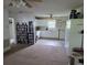 Open floor plan showcasing the living room with adjacent kitchen featuring white cabinetry at 60 Caboose Ct, Cottageville, SC 29435